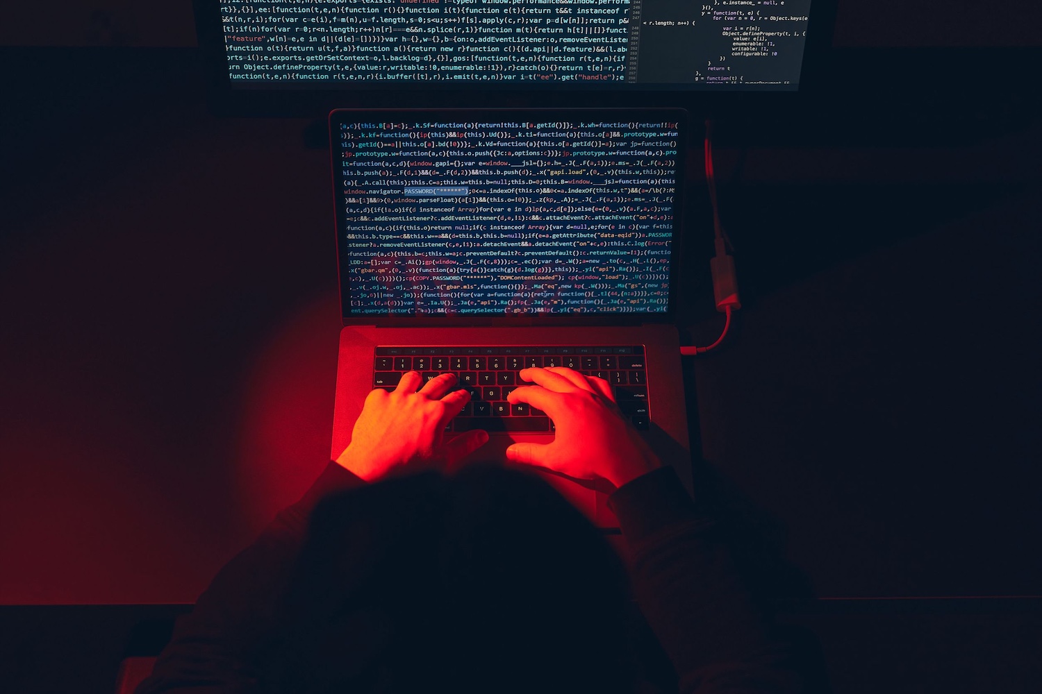 person using computer and programming to break code