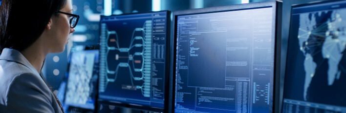 person with three monitors mobile 708x232 1 1