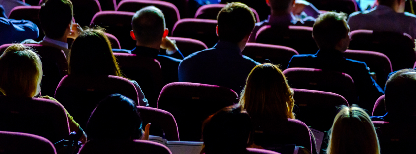 Group of people are seated in a theater
