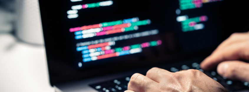 case study of trojan virus Human types code on laptop keyboard