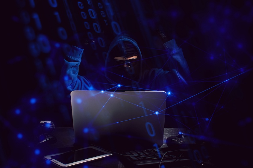 hacker with hands up and blue number overlay