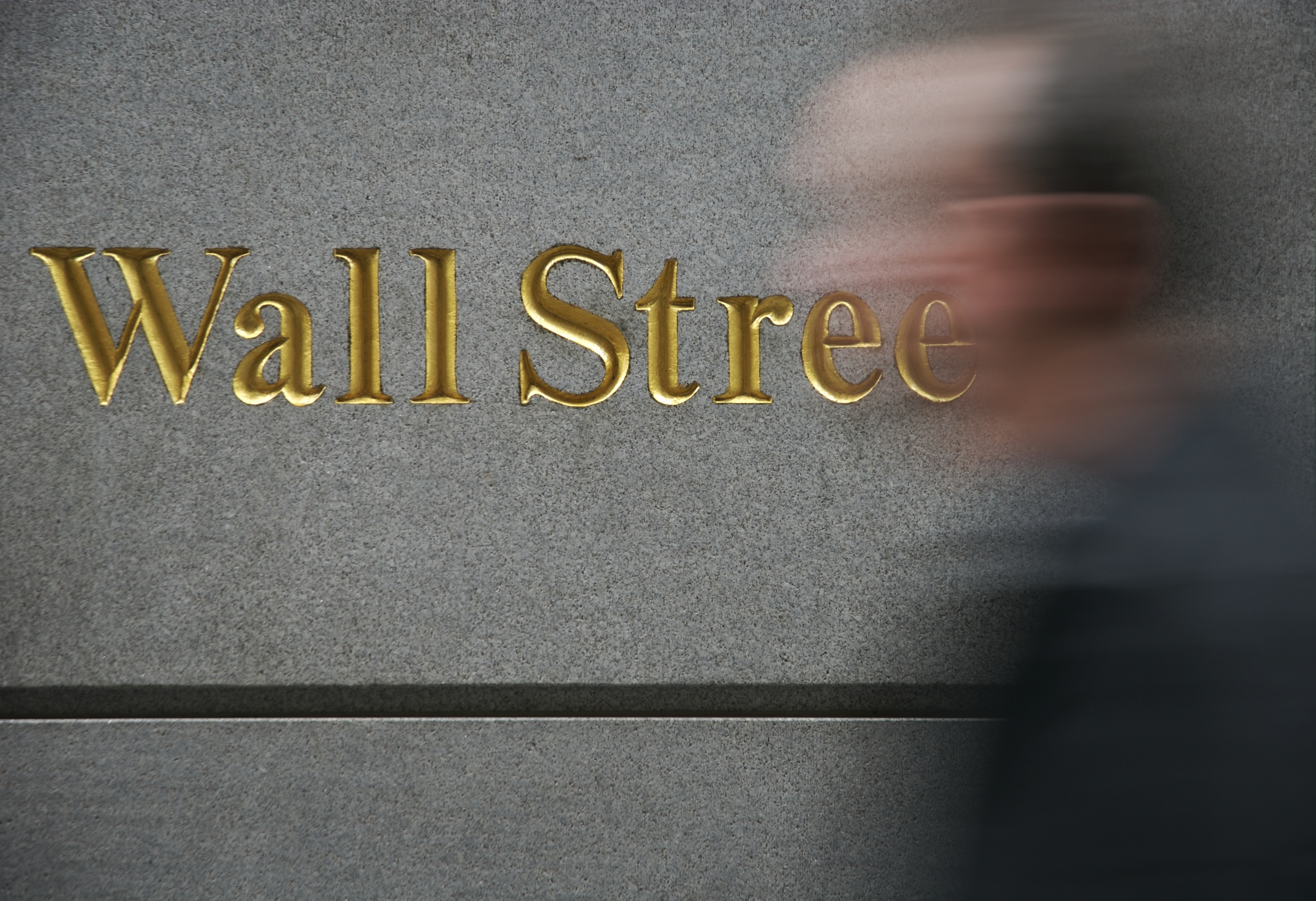 Gold Wall Street Sign Motion Blur Man stock photo Julia Wiltshire